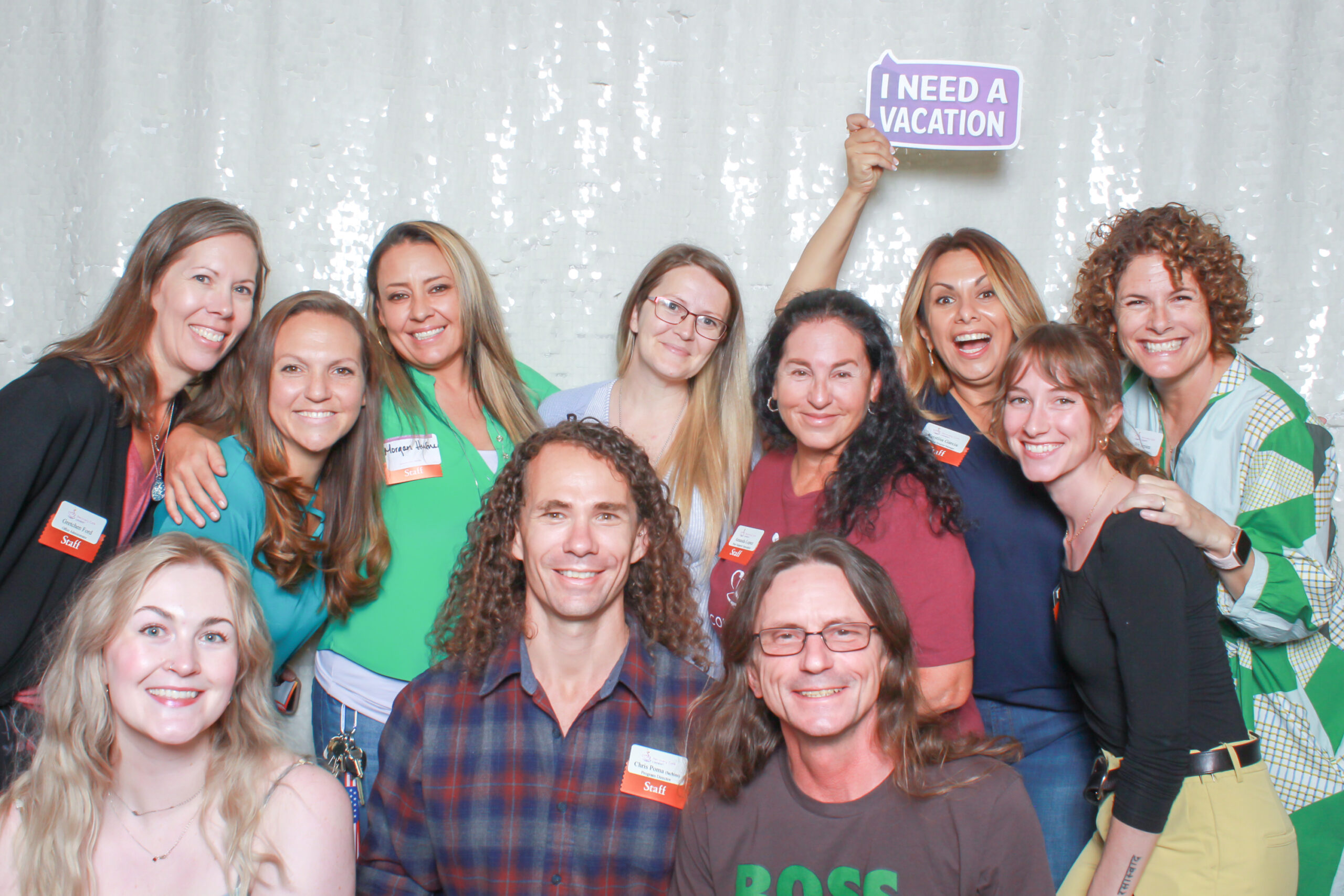 Our Team: Recovery Café Longmont staff smiling together at a community celebration, showing connection, joy, and teamwork.