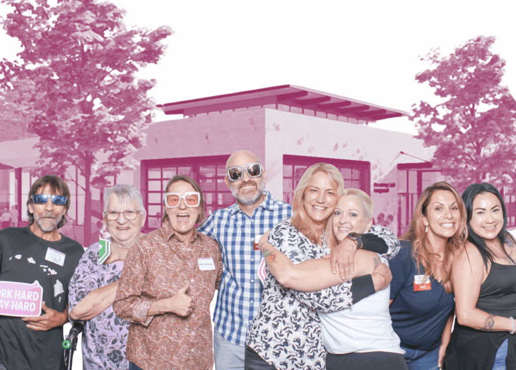 Recovery Café Longmont community members smile, superimposed in front of a stylized image of our new home at 801 Main St.
