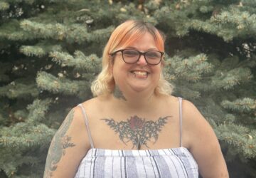 Café member Sara smiles and celebrates the love and belonging she's found in the Café community.